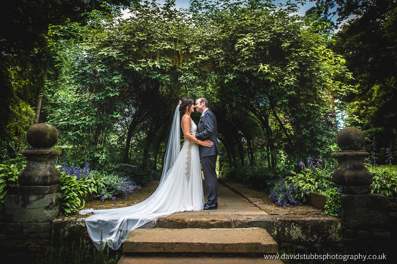 bride and groom in arch