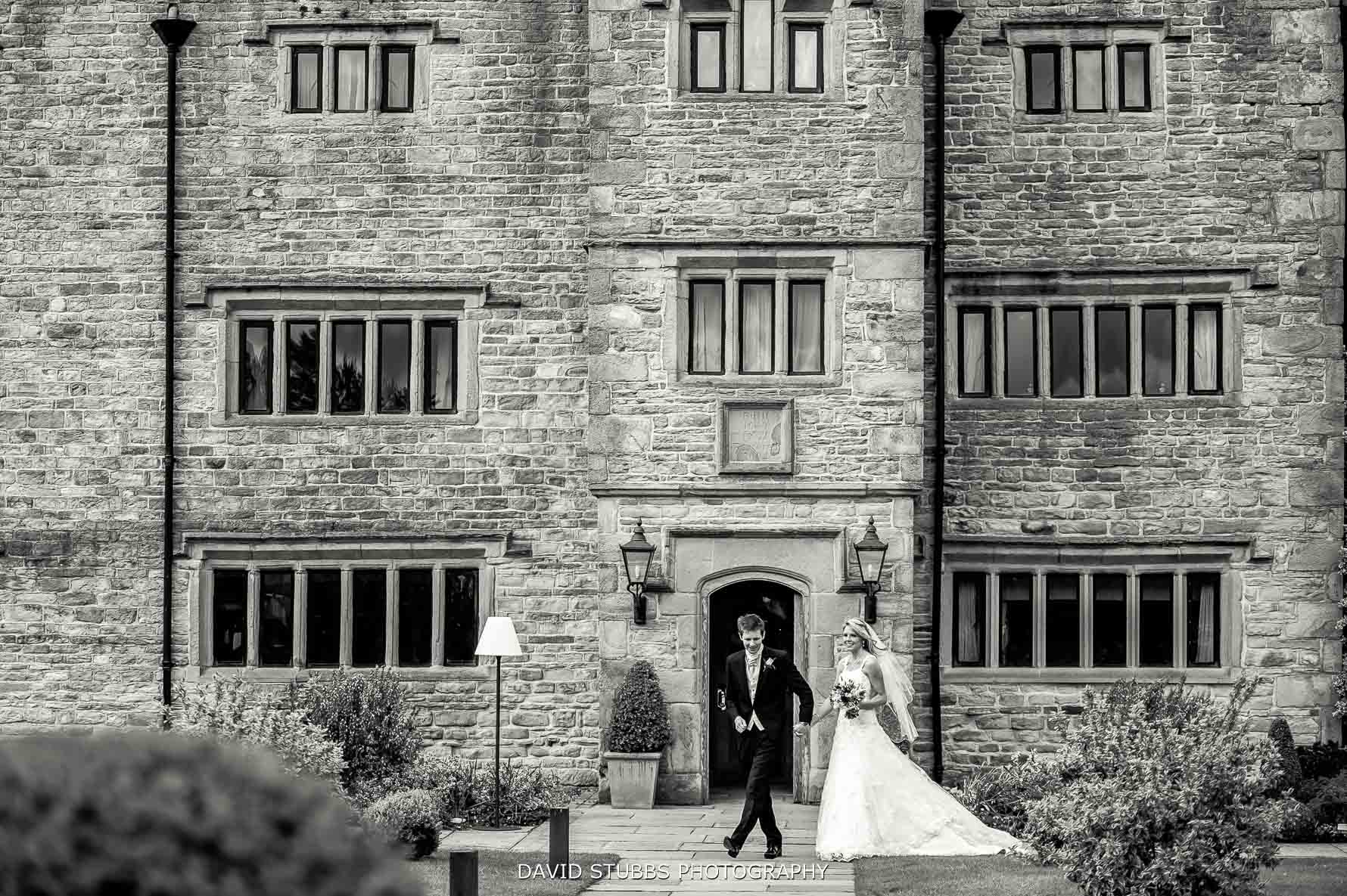 couple walking together in front of manor house