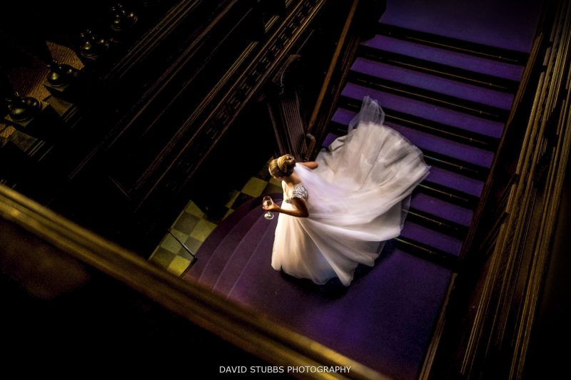 bride walking down the stairs at eaves hall wedding
