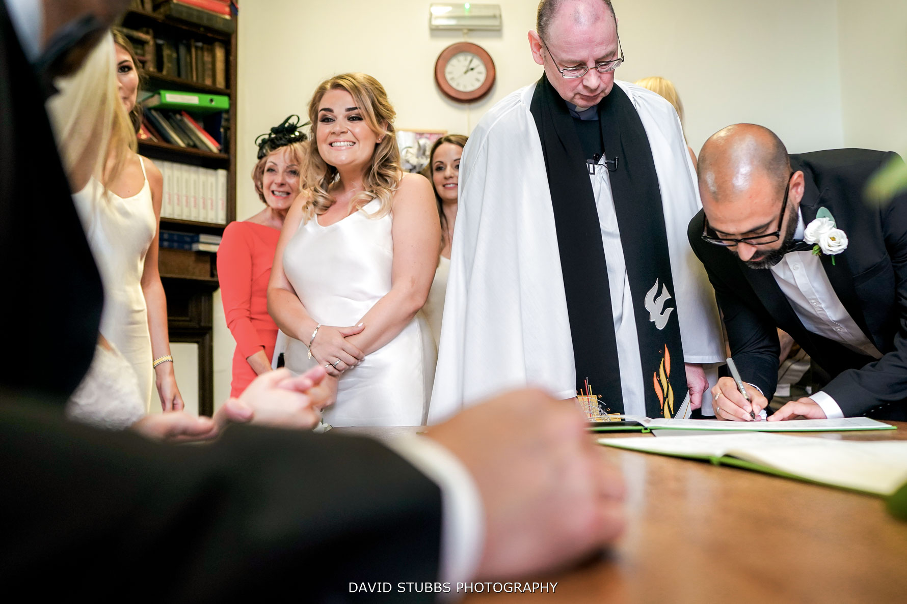 signing the register to confirm the marriage