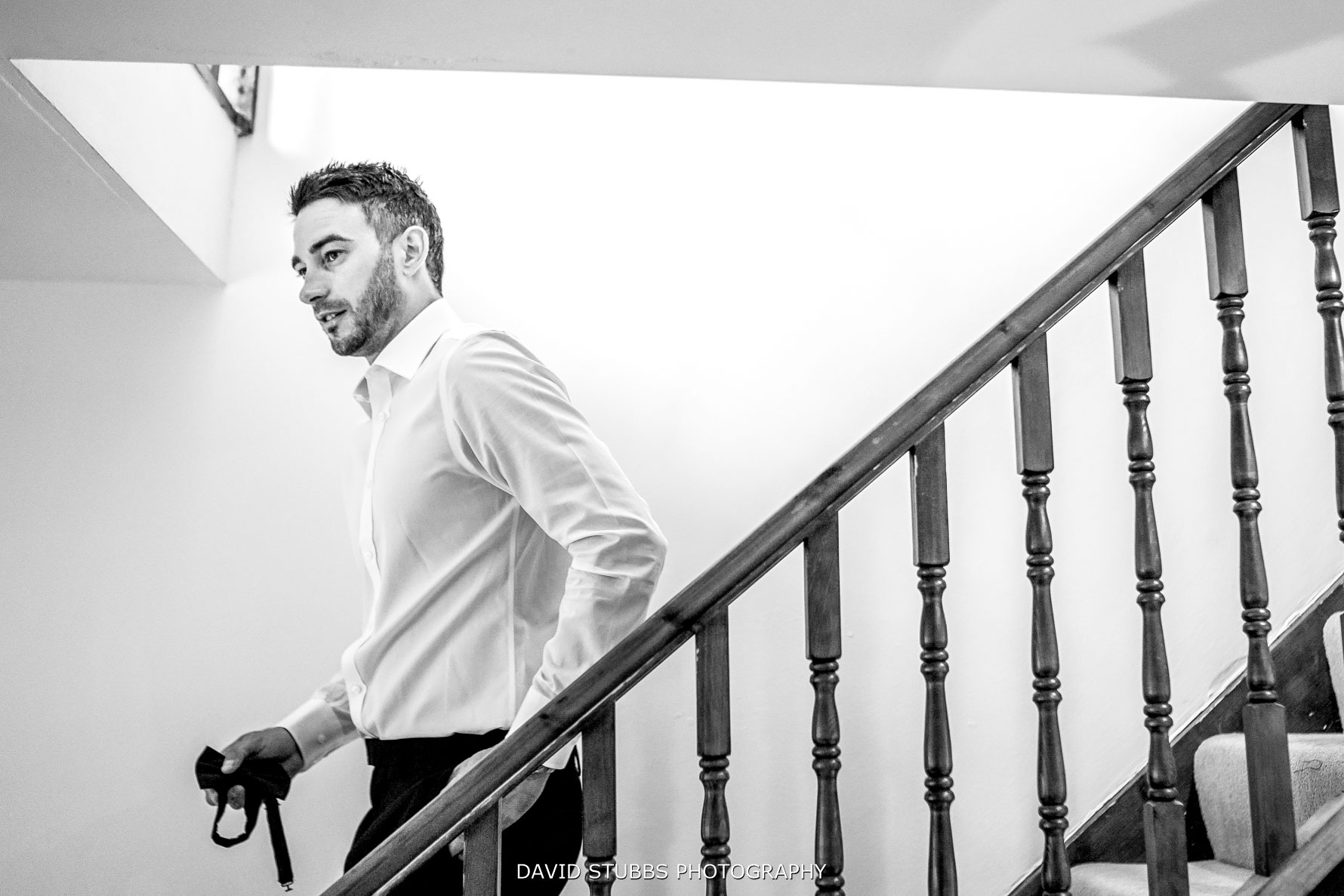 groom walking down the stairs nervously