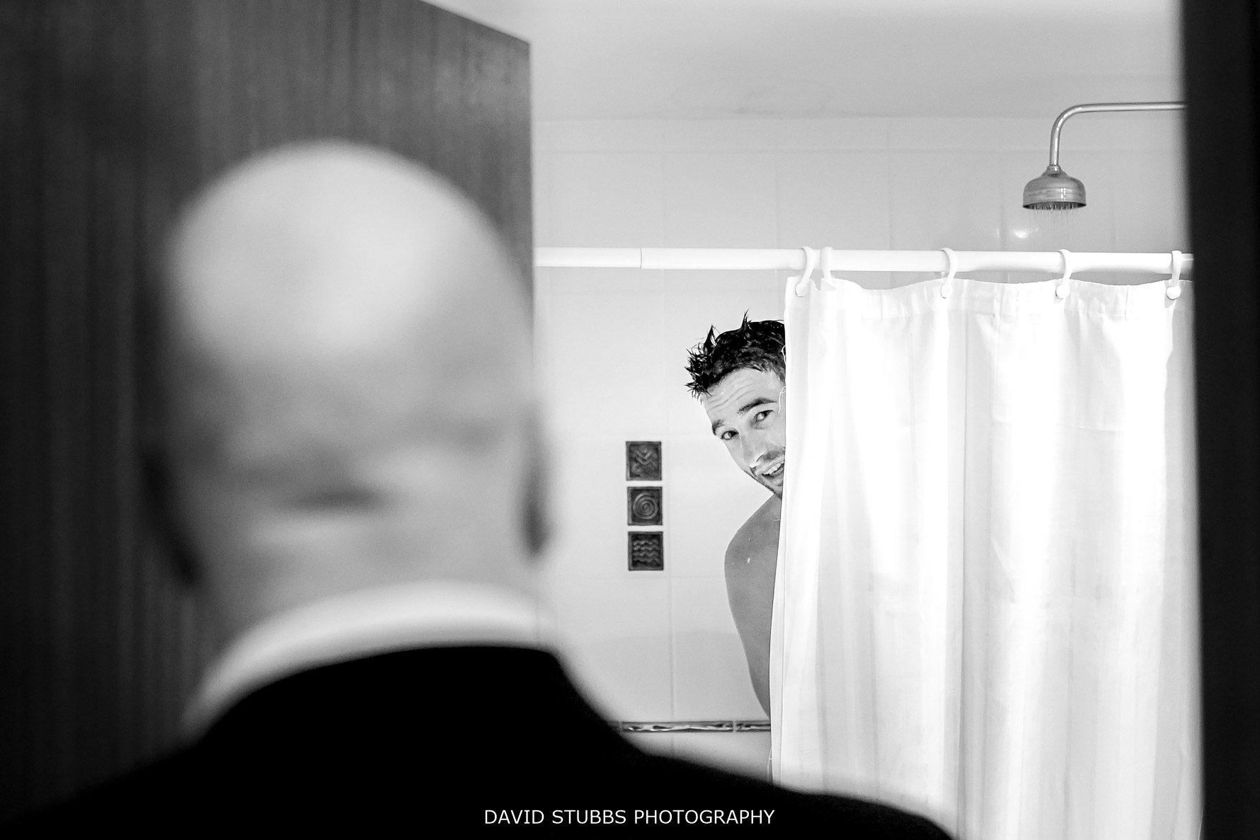 groom in the shower in black and white