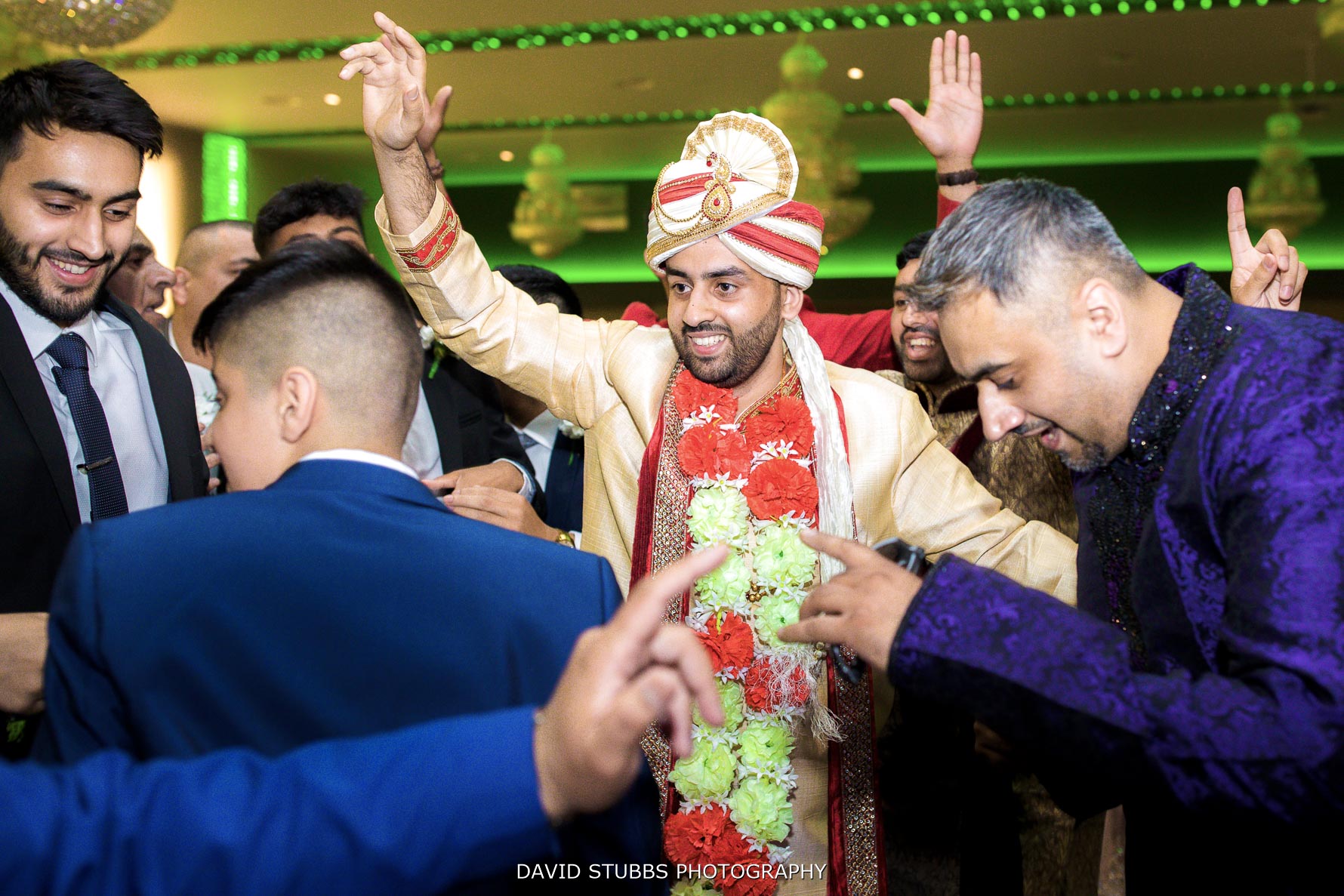 all family dance around him in the hall