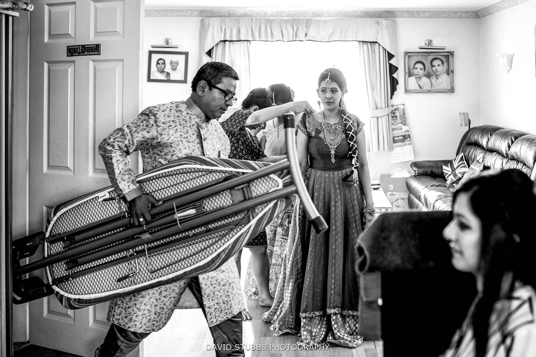 walking through the room with a ironing board