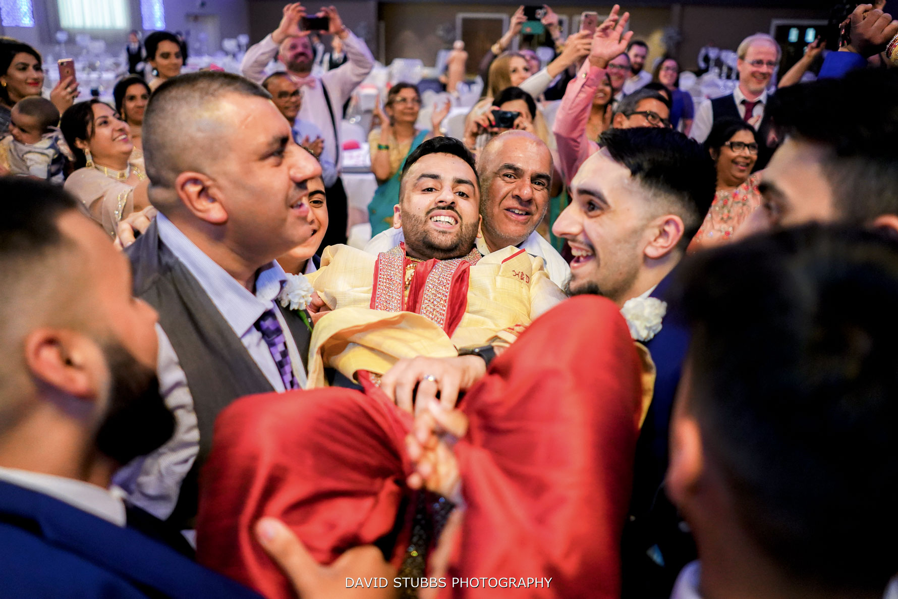 being picked up again by groomsmen