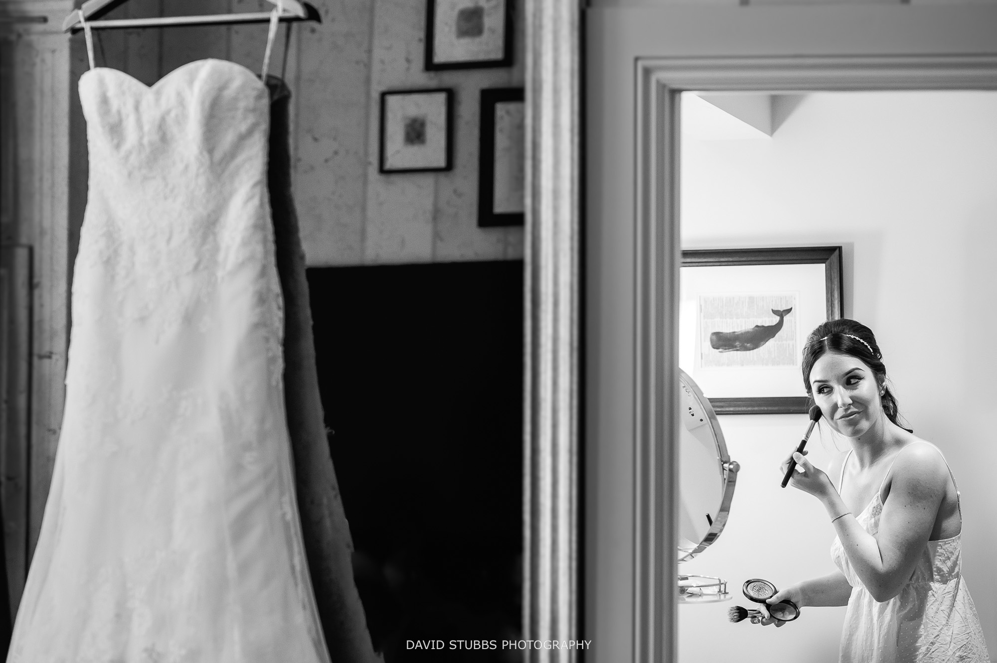 bride doing make-up before wedding